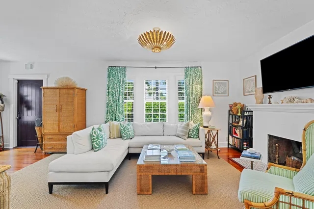 a living room with furniture a flat screen tv and a fireplace