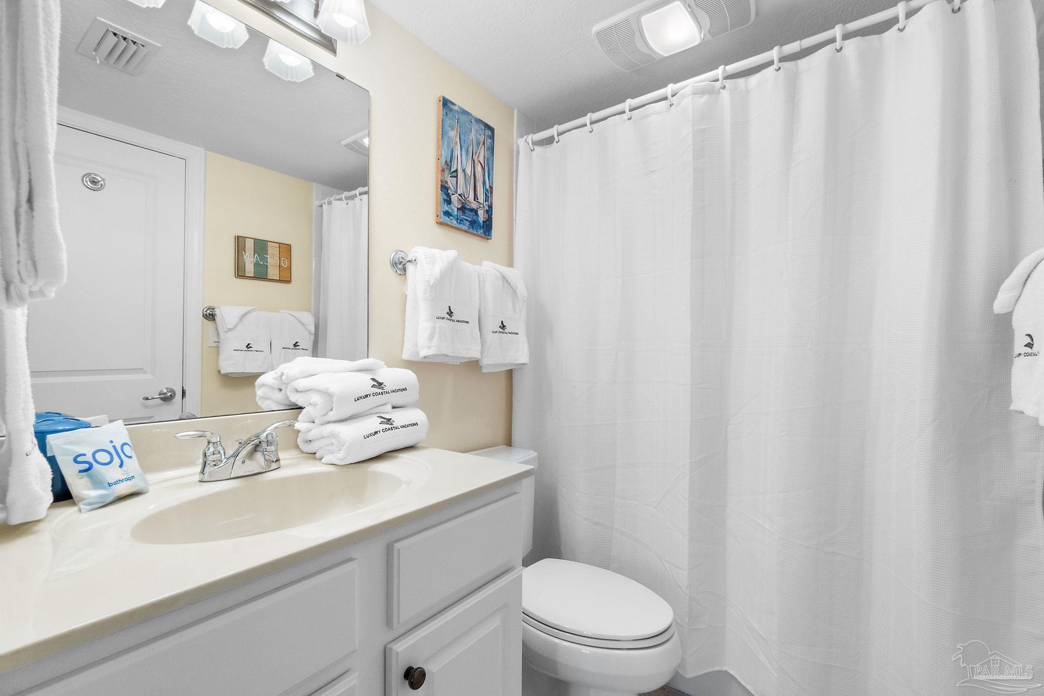 16785 Perdido Key Drive, Unit 503 Perdido Key, FL 32507 - Photo 21 of 38 a bathroom with a sink a toilet and shower curtain