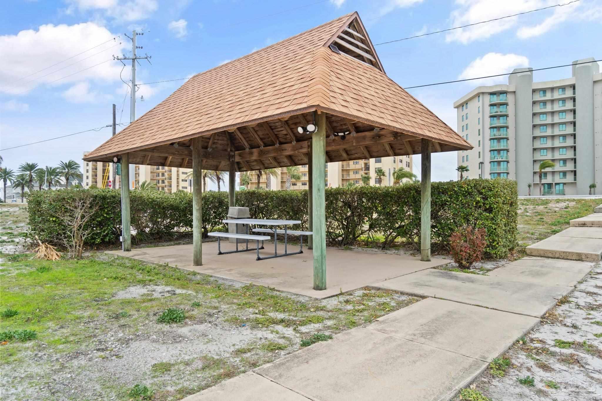 16785 Perdido Key Drive, Unit 503 Perdido Key, FL 32507 - Photo 34 of 38 a view of a patio with a table and chairs under an umbrella