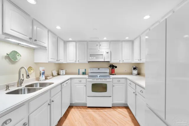 a kitchen with a sink a stove and cabinets