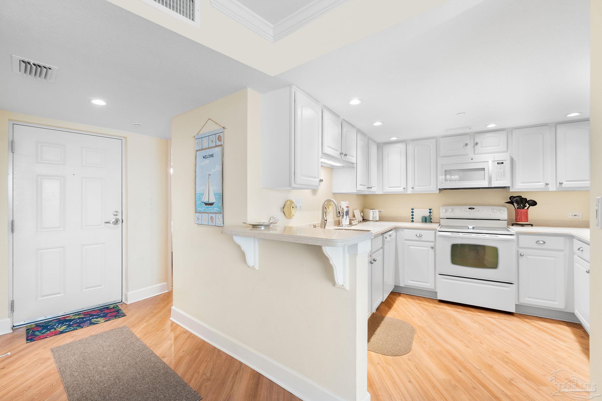 16785 Perdido Key Drive, Unit 503 Perdido Key, FL 32507 - Photo 10 of 38 a kitchen with white cabinets appliances and a sink