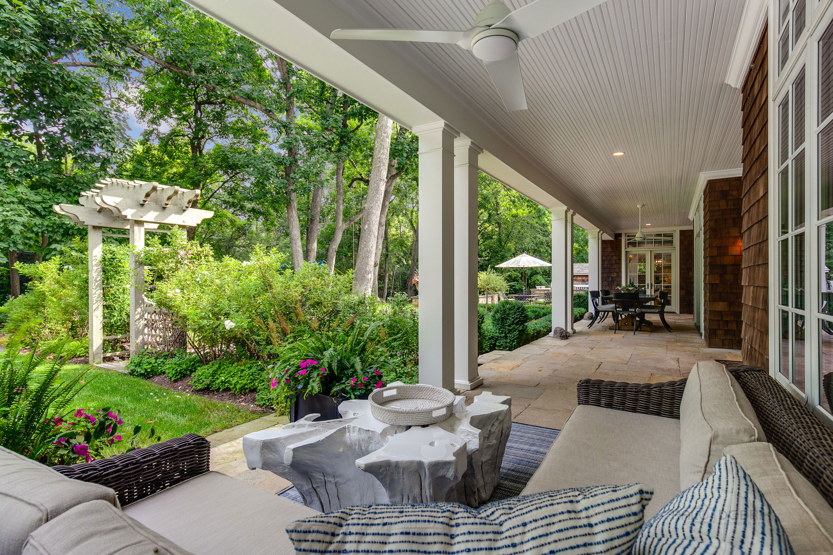 680 South Ridge Road Lake Forest, IL 60045 - Photo 39 of 44 a view of a patio with couches table and chairs potted plants and large tree