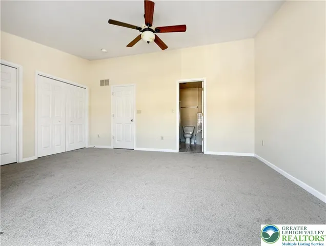 a view of a livingroom with a ceiling fan and window
