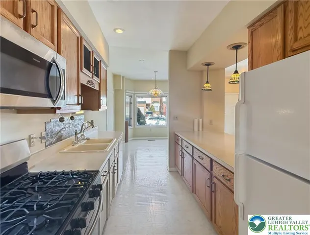 a kitchen with refrigerator and window