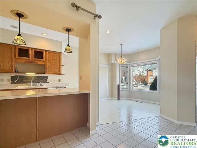 a kitchen with stainless steel appliances granite countertop a sink a stove top oven a refrigerator and a granite counter tops