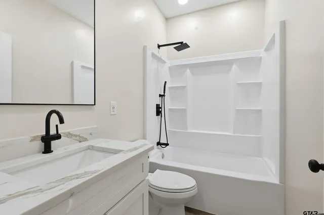 an empty room with wooden floor and a ceiling fan