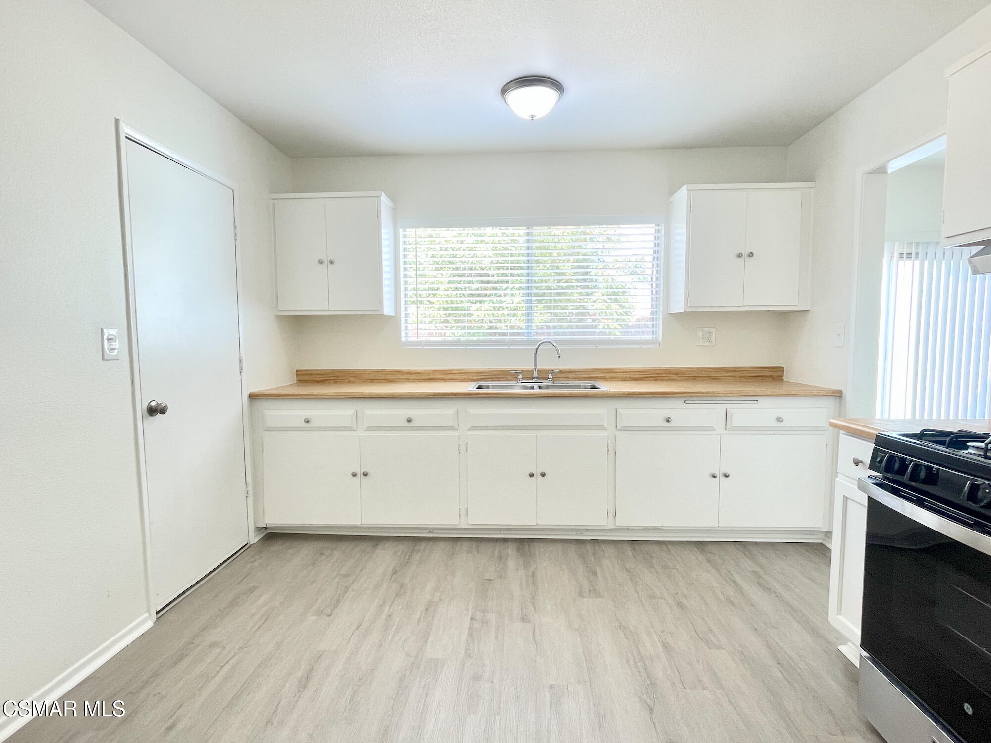 4327 Lou Drive Simi Valley, CA 93063 - Photo 11 of 23 a kitchen with granite countertop white cabinets white stainless steel appliances and a window