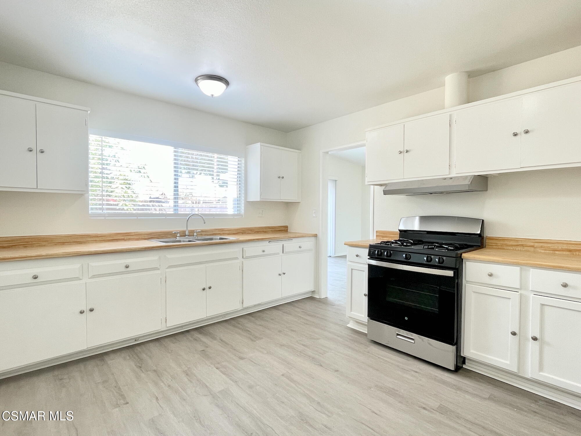 4327 Lou Drive Simi Valley, CA 93063 - Photo 9 of 23 a kitchen with granite countertop white cabinets and appliances