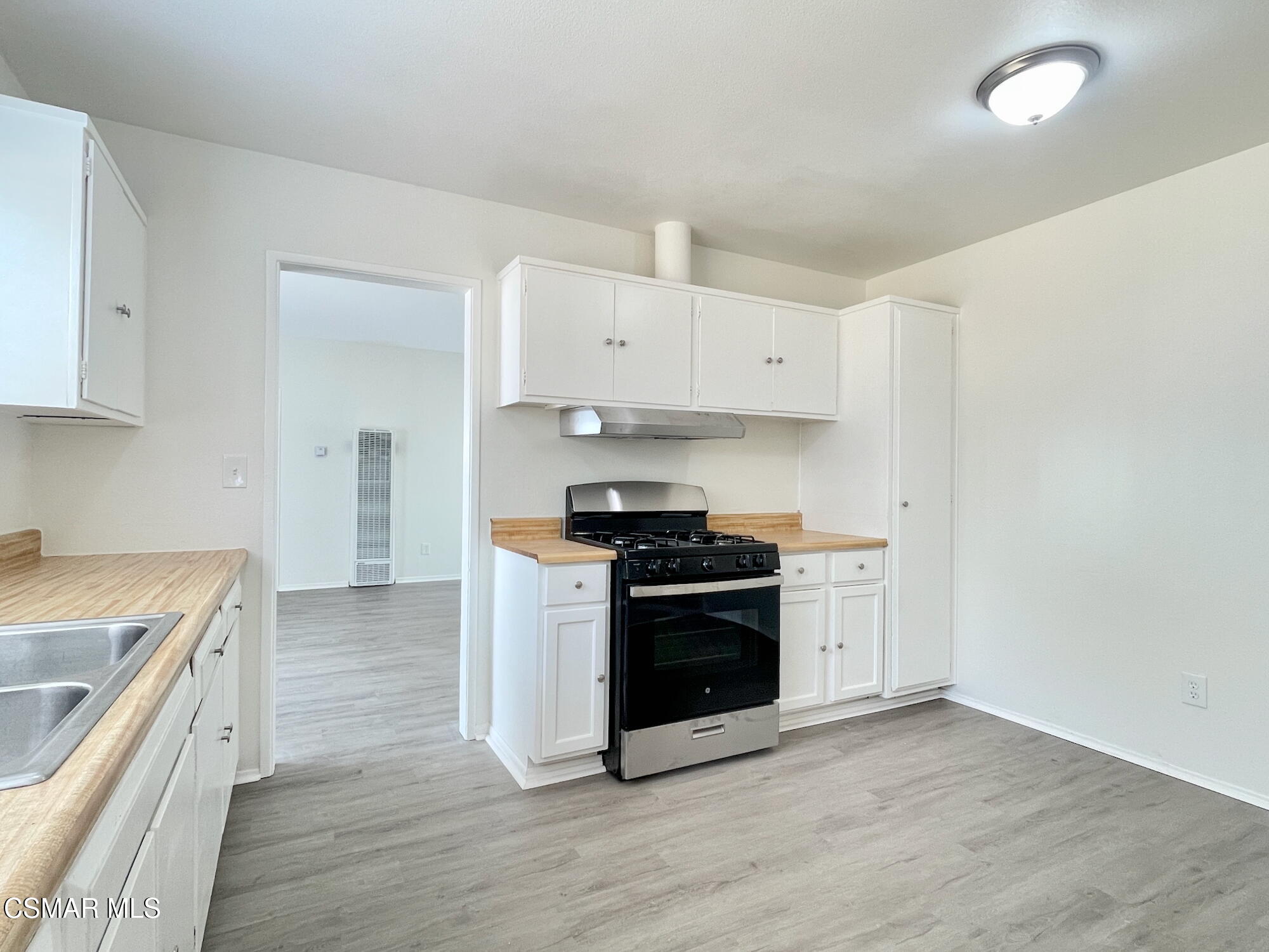 4327 Lou Drive Simi Valley, CA 93063 - Photo 10 of 23 a kitchen with a stove top oven and cabinets