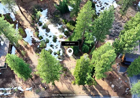 an aerial view of a house yard and mountain view in back