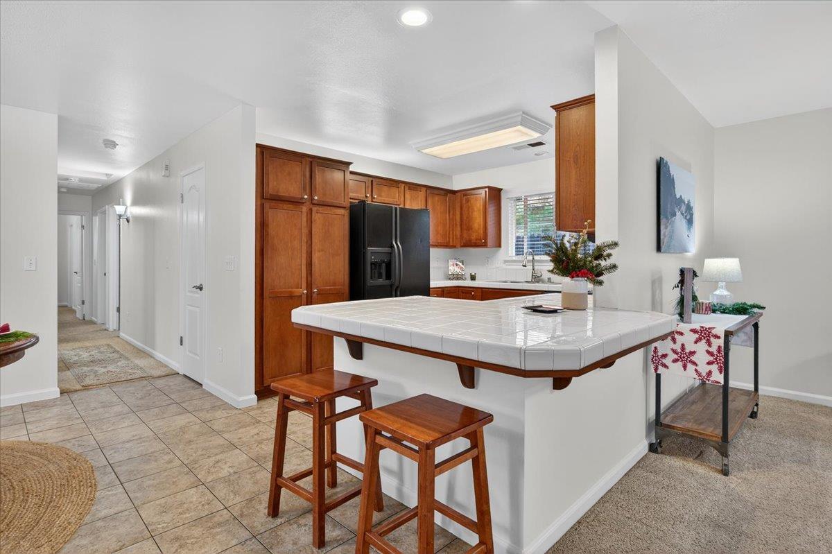 4776 East Rialto Avenue Fresno, CA 93726 - Photo 11 of 54 a kitchen that has a table and chairs in it