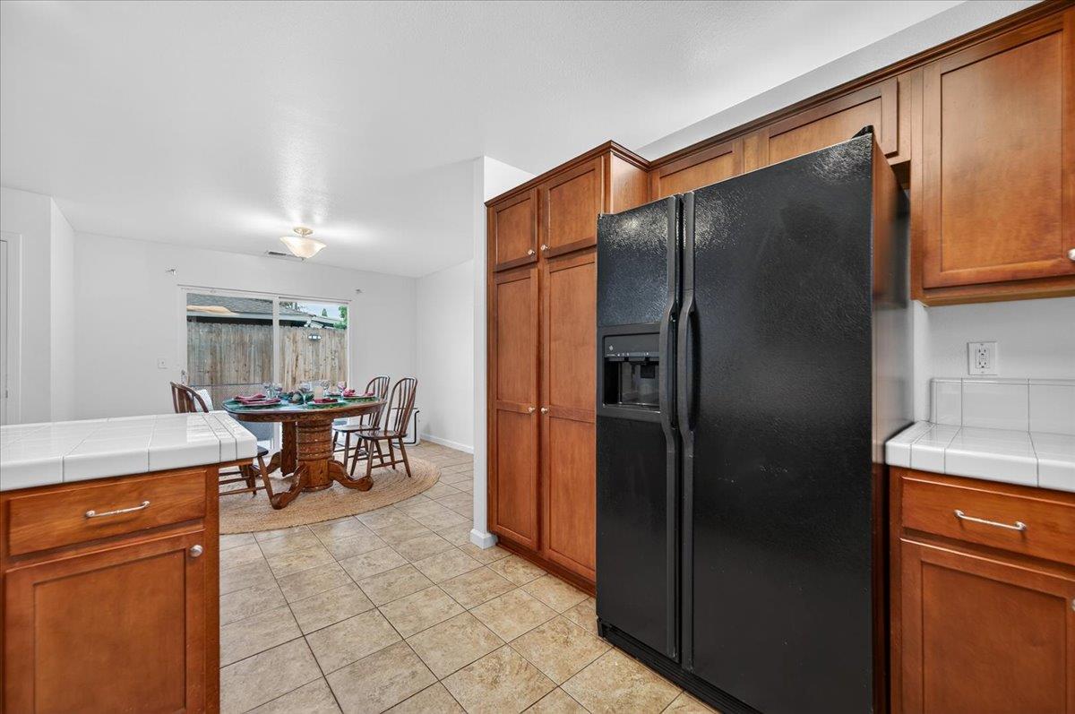 4776 East Rialto Avenue Fresno, CA 93726 - Photo 17 of 54 a kitchen with stainless steel appliances granite countertop a refrigerator and a stove top oven