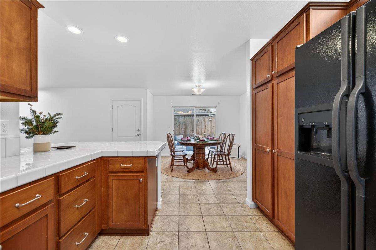 4776 East Rialto Avenue Fresno, CA 93726 - Photo 18 of 54 a kitchen with stainless steel appliances granite countertop a refrigerator a sink a stove and white cabinets