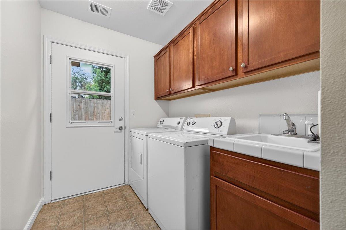 4776 East Rialto Avenue Fresno, CA 93726 - Photo 21 of 54 a utility room with cabinets washer and dryer