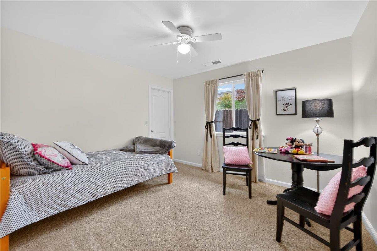 4776 East Rialto Avenue Fresno, CA 93726 - Photo 27 of 54 a bedroom with a bed and a chandelier