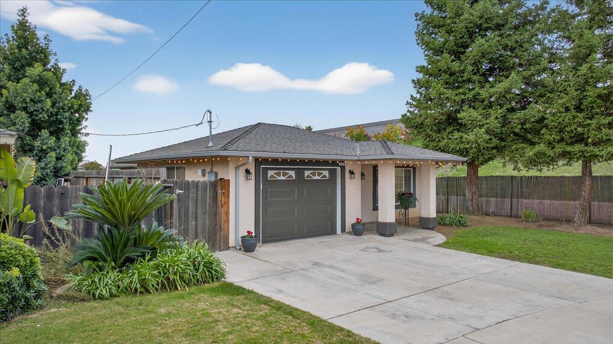 4776 East Rialto Avenue Fresno, CA 93726 - Photo 3 of 54 a front view of a house with a yard and garage