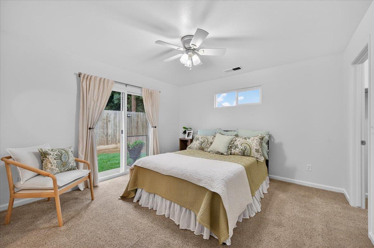 4776 East Rialto Avenue Fresno, CA 93726 - Photo 32 of 54 a bedroom with a bed and a chandelier