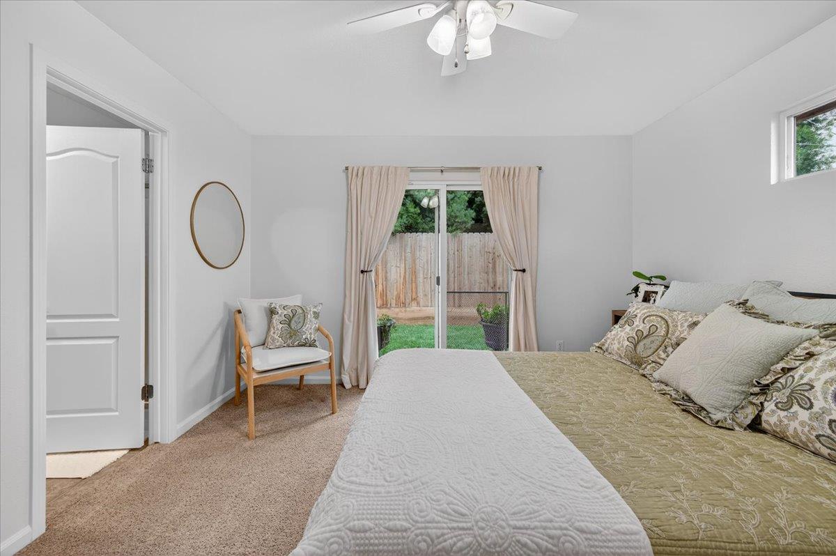 4776 East Rialto Avenue Fresno, CA 93726 - Photo 35 of 54 a bedroom with a bed a chandelier and a window