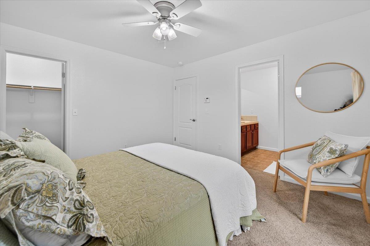 4776 East Rialto Avenue Fresno, CA 93726 - Photo 37 of 54 a bedroom with a bed and a chandelier