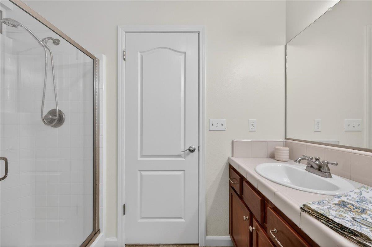 4776 East Rialto Avenue Fresno, CA 93726 - Photo 39 of 54 a bathroom with a granite countertop sink and a mirror