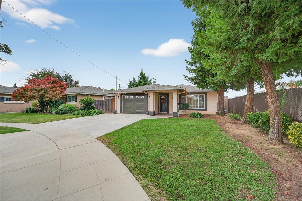 4776 East Rialto Avenue Fresno, CA 93726 - Photo 40 of 54 a front view of a house with a yard and potted plants