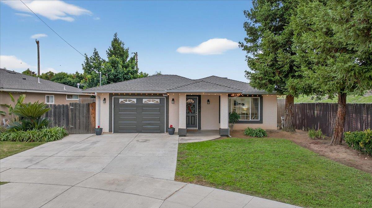 4776 East Rialto Avenue Fresno, CA 93726 - Photo 4 of 54 a front view of a house with garden