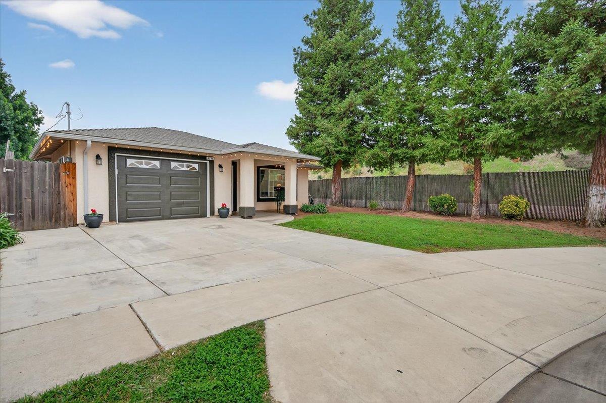4776 East Rialto Avenue Fresno, CA 93726 - Photo 41 of 54 a front view of house with yard and green space