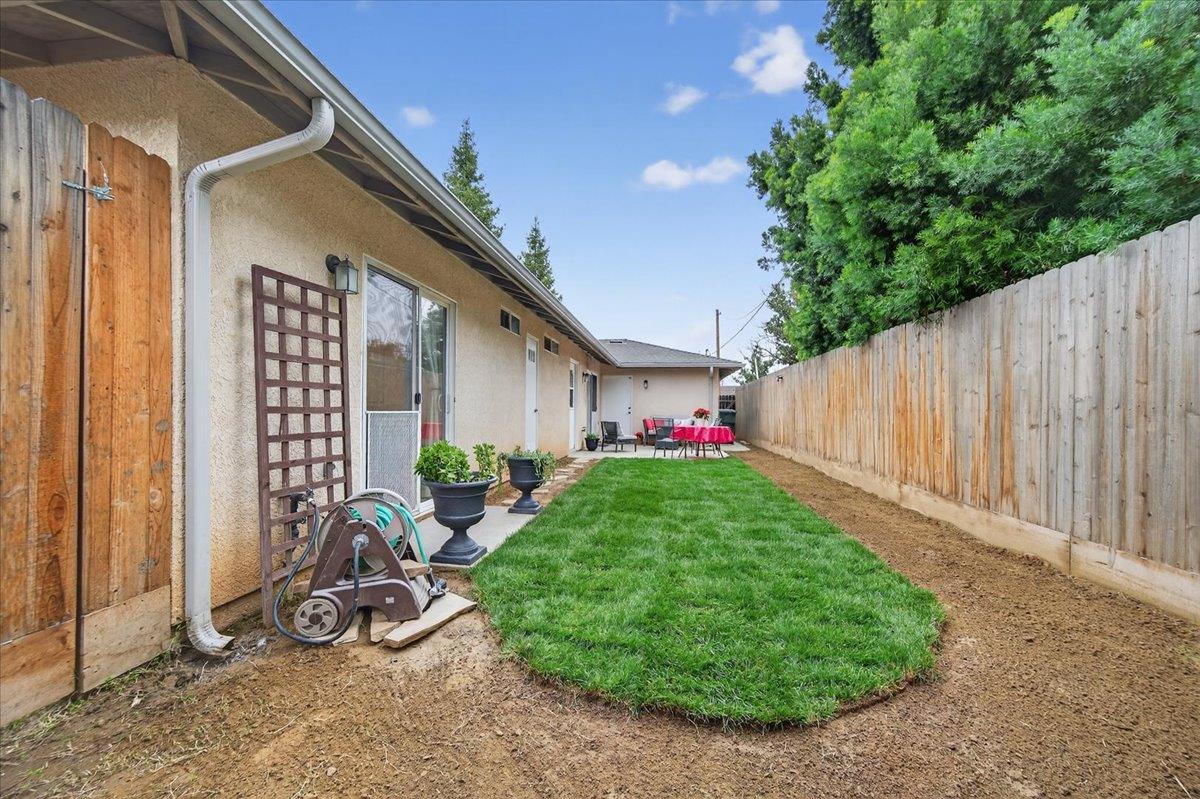 4776 East Rialto Avenue Fresno, CA 93726 - Photo 47 of 54 a view of a backyard with plants and a table and chair