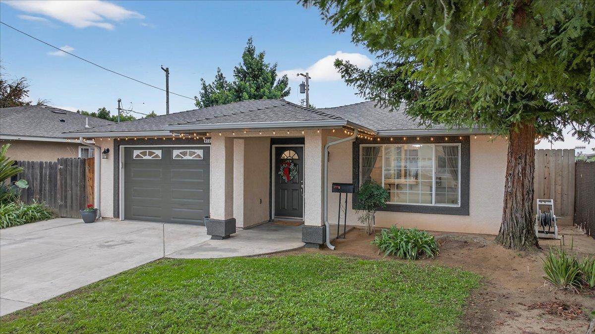 4776 East Rialto Avenue Fresno, CA 93726 - Photo 5 of 54 a front view of a house with a yard
