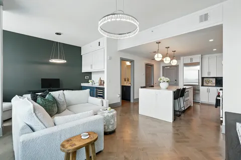 a living room with furniture and kitchen view