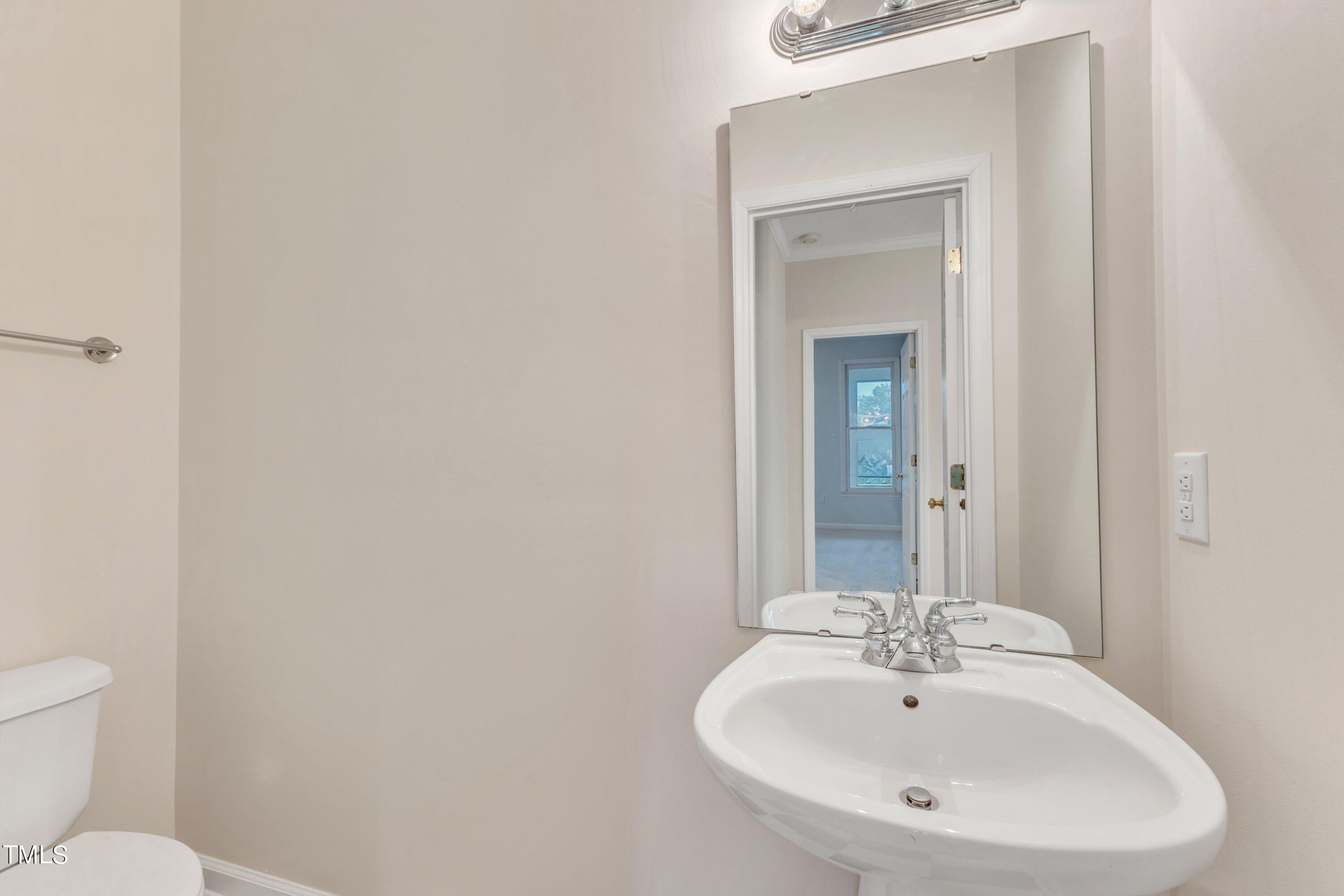 720 North Person Street, Unit 306 Raleigh, NC 27604 - Photo 11 of 13 a bathroom with a sink and a mirror