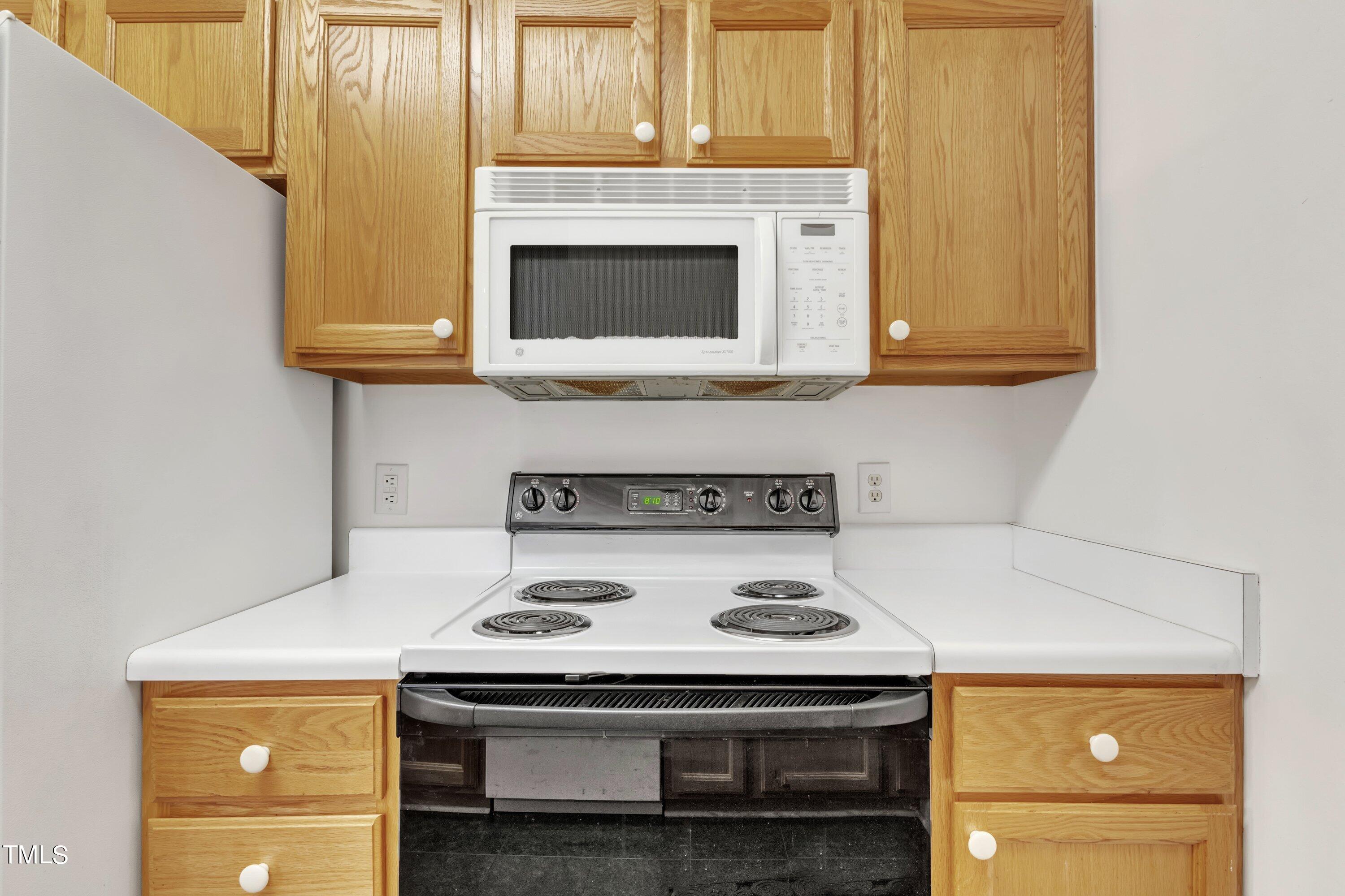 720 North Person Street, Unit 306 Raleigh, NC 27604 - Photo 4 of 13 a kitchen with a stove and a microwave