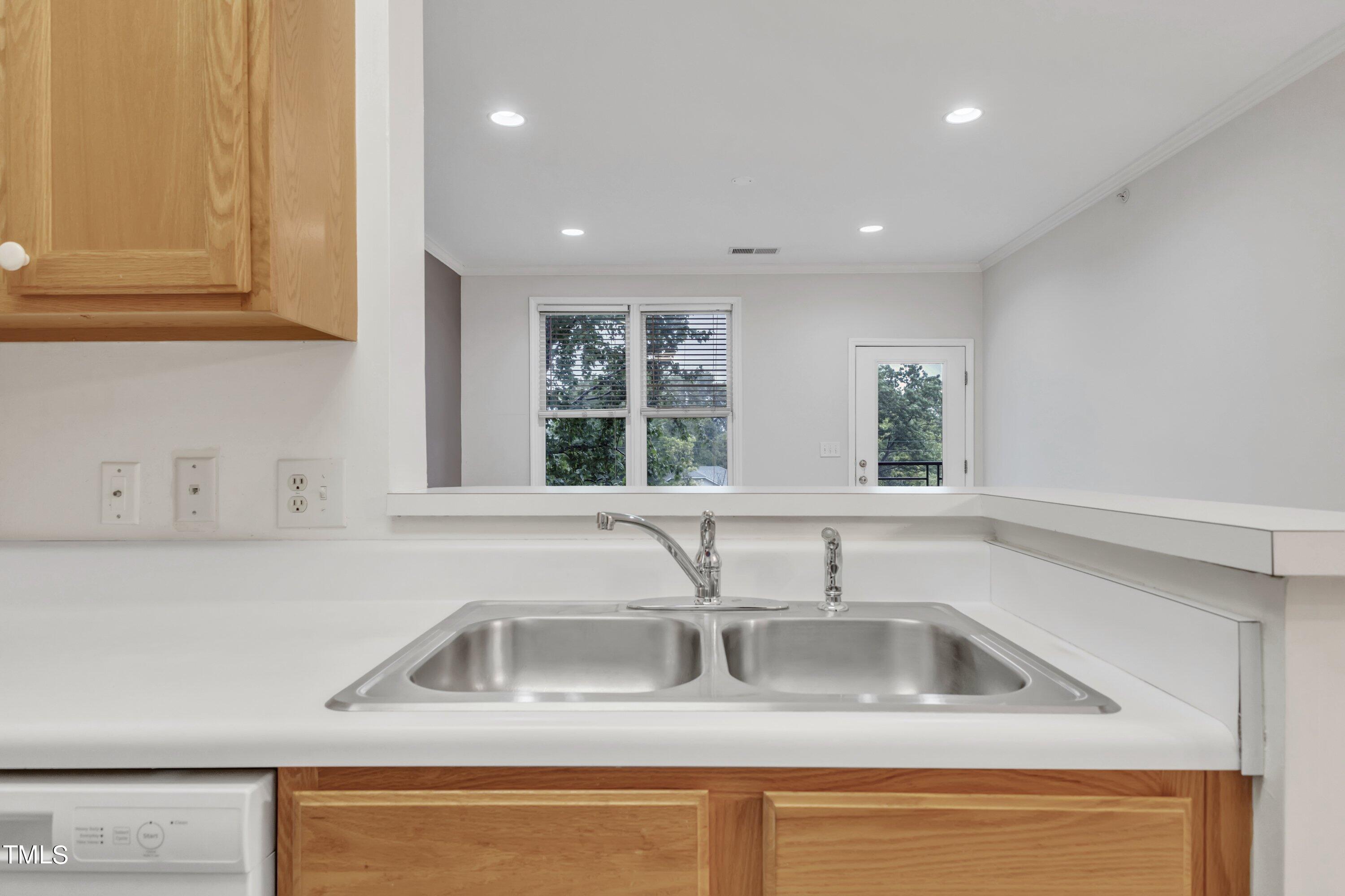 720 North Person Street, Unit 306 Raleigh, NC 27604 - Photo 5 of 13 a kitchen with stainless steel appliances granite countertop a sink and a window