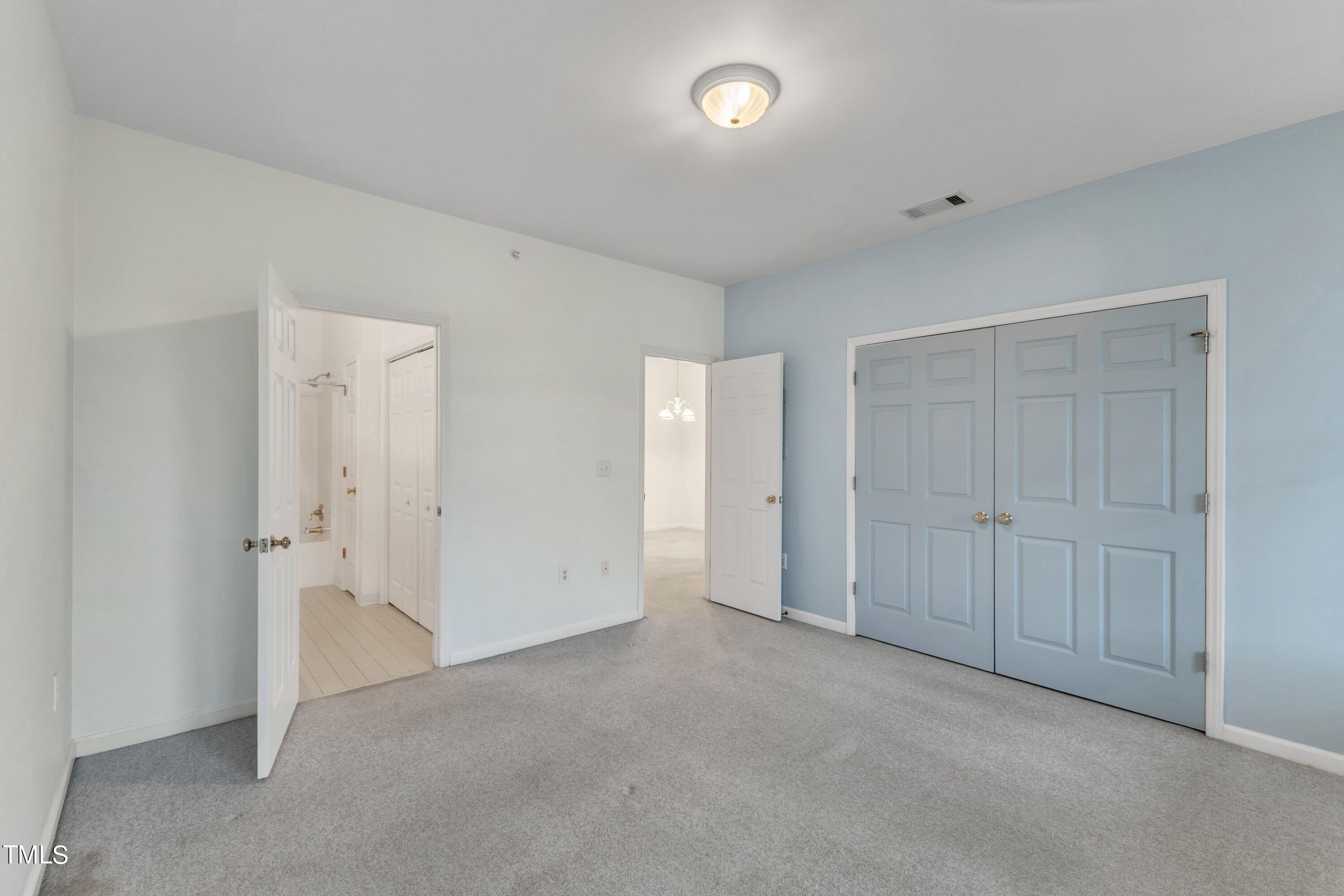 720 North Person Street, Unit 306 Raleigh, NC 27604 - Photo 8 of 13 an empty room with closet area