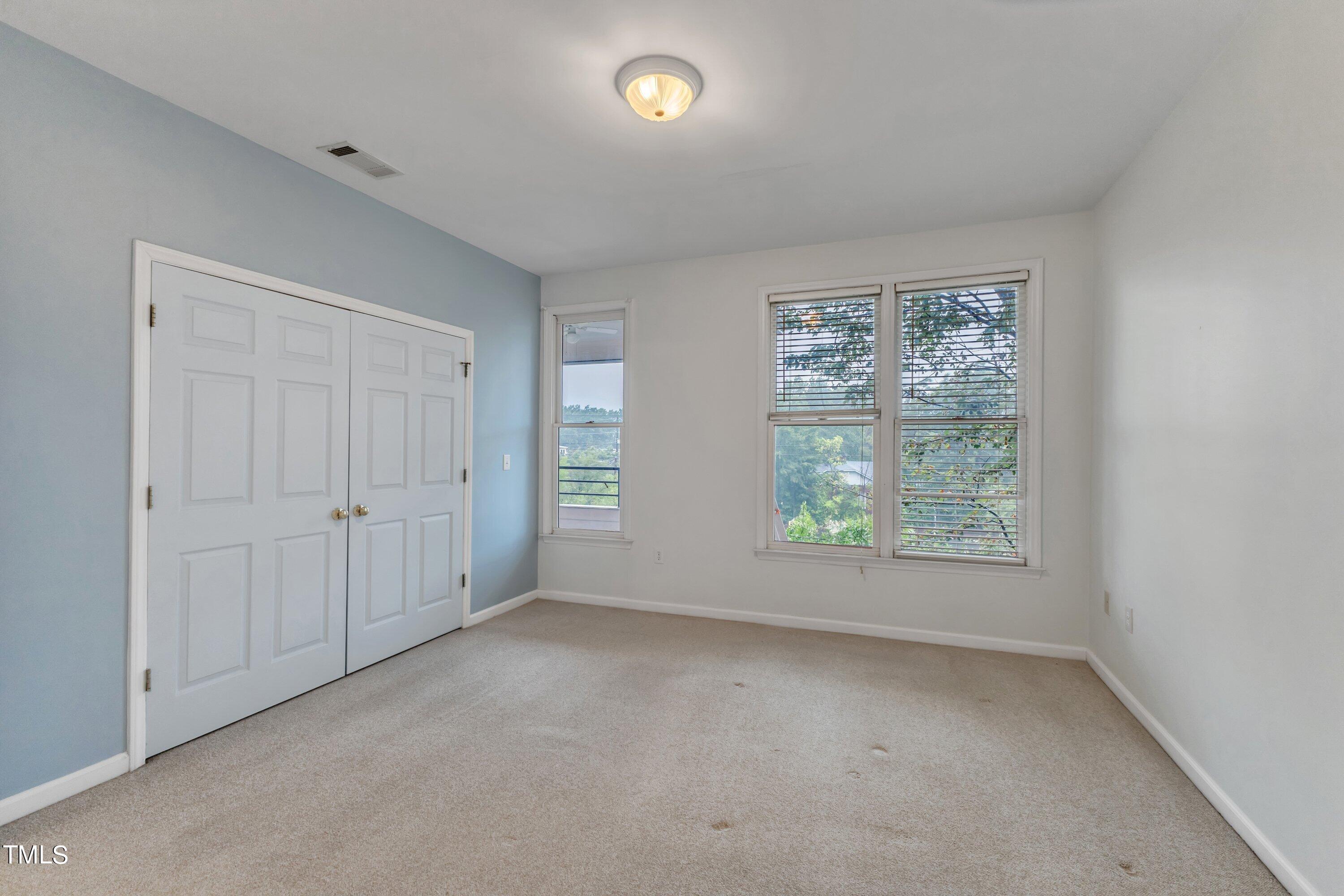 720 North Person Street, Unit 306 Raleigh, NC 27604 - Photo 9 of 13 an empty room with a empty space and windows