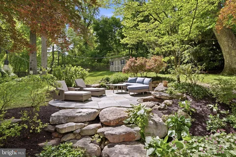 a view of a backyard with sitting area