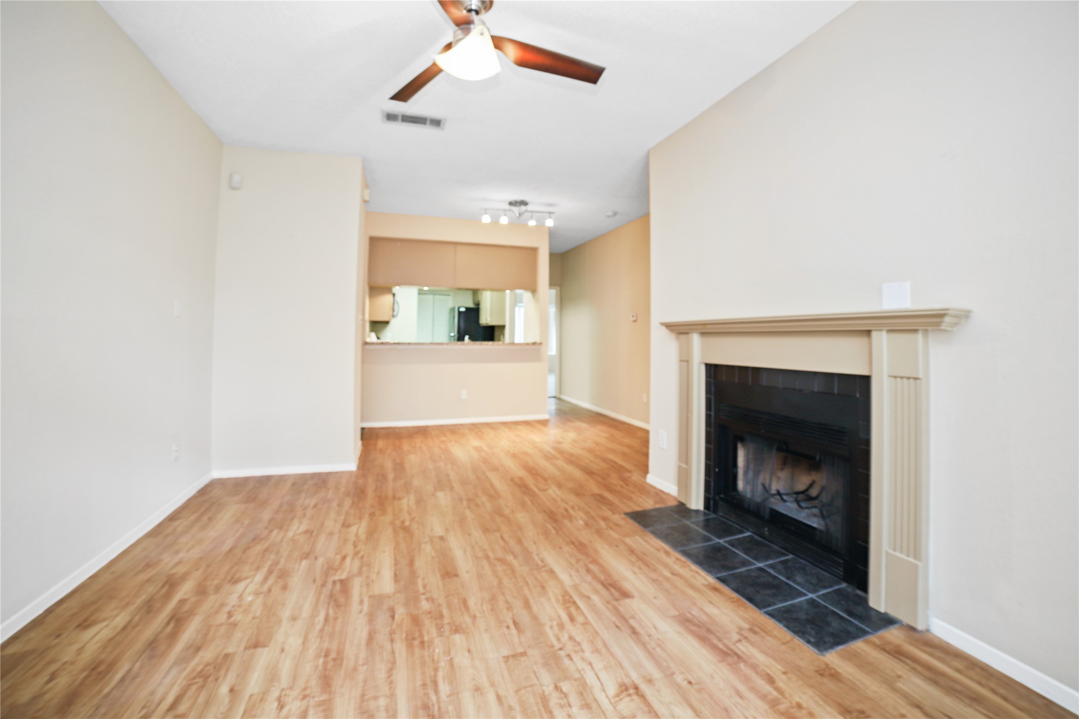 806 West 24th Street, Unit 220 Austin, TX 78705 - Photo 4 of 10 a view of an empty room with wooden floor fireplace and a window