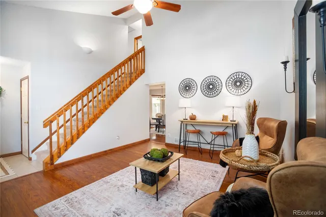 a living room with furniture and a clock