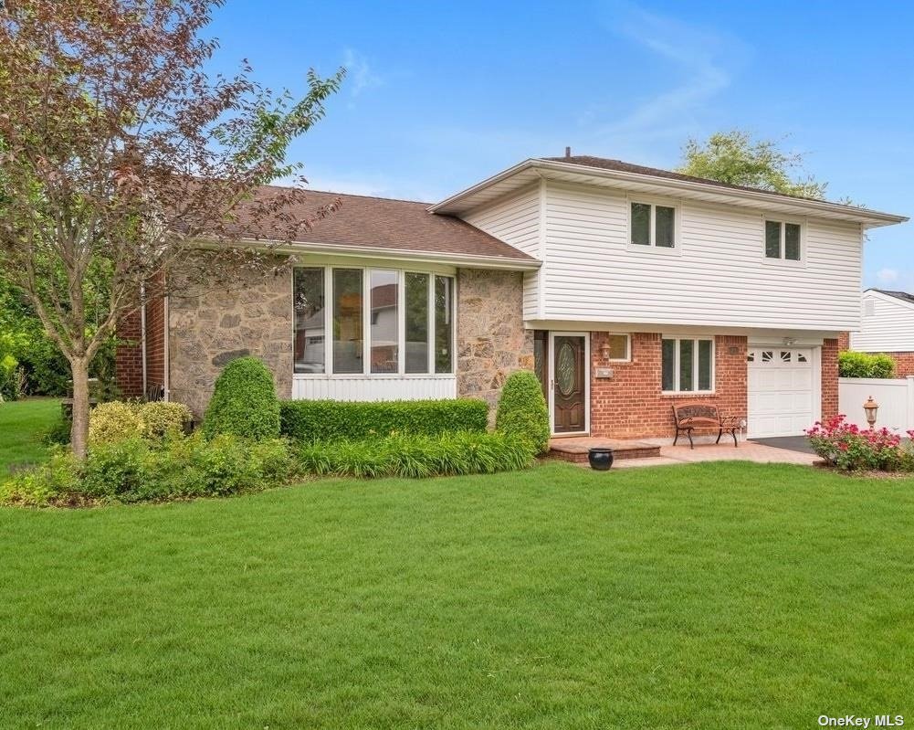 23 Myron Road Plainview, NY 11803 - Photo 1 of 1 a front view of a house with a garden