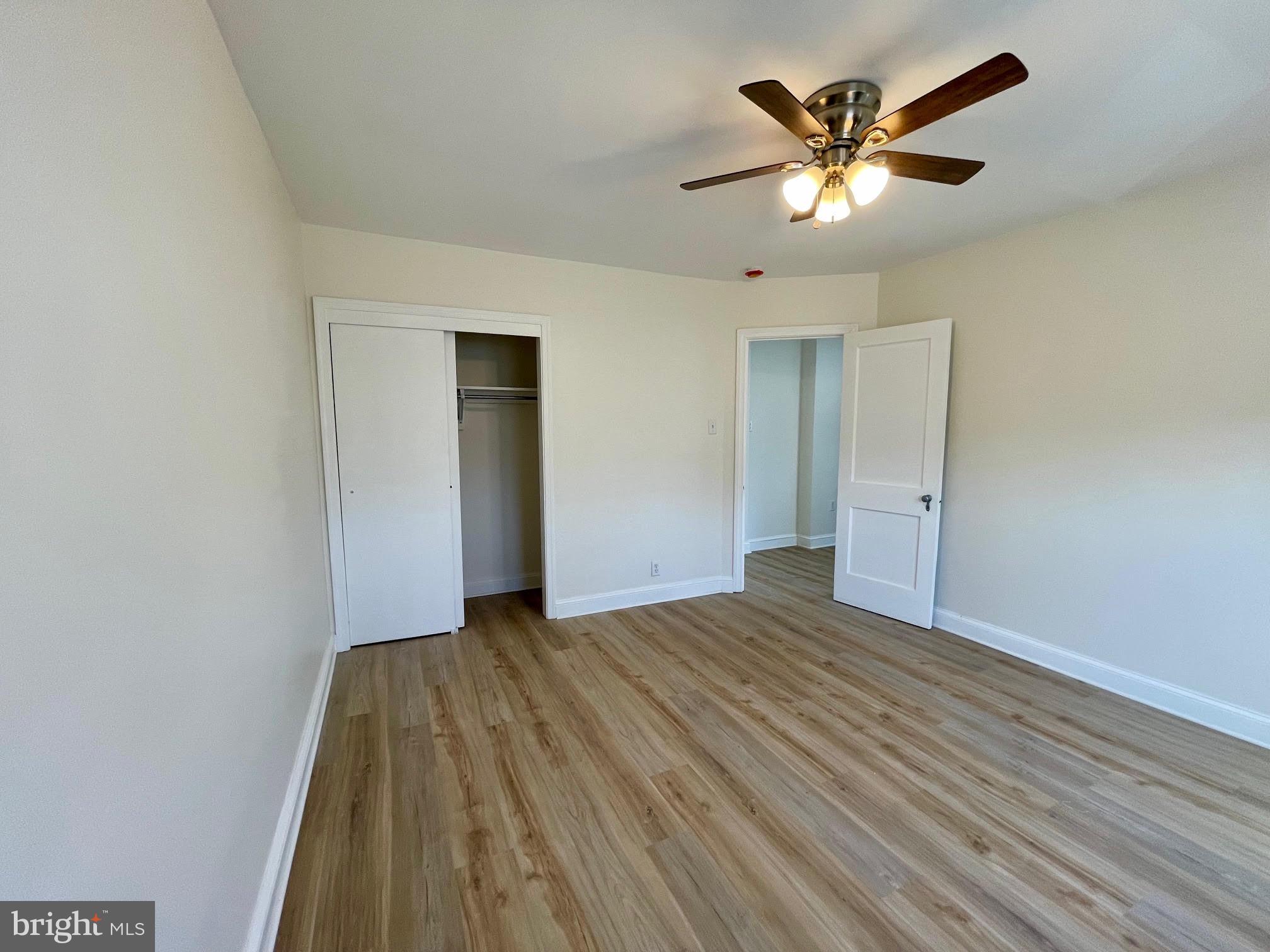 416 East Providence Road Aldan, PA 19018 - Photo 6 of 12 an empty room with wooden floor and a ceiling fan