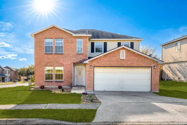 a front view of a house with a garden and plants