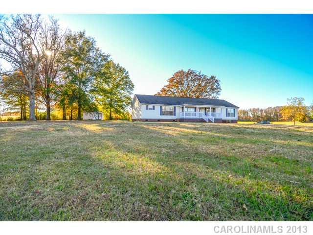 4520 Plyler Mill Road Monroe, NC 28112 - Photo 2 of 16 a view of a big room with a big yard and large trees