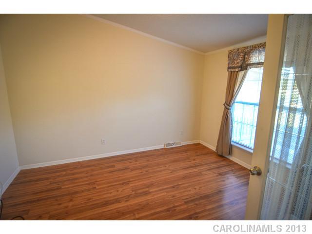 4520 Plyler Mill Road Monroe, NC 28112 - Photo 11 of 16 a view of an empty room with wooden floor and a window
