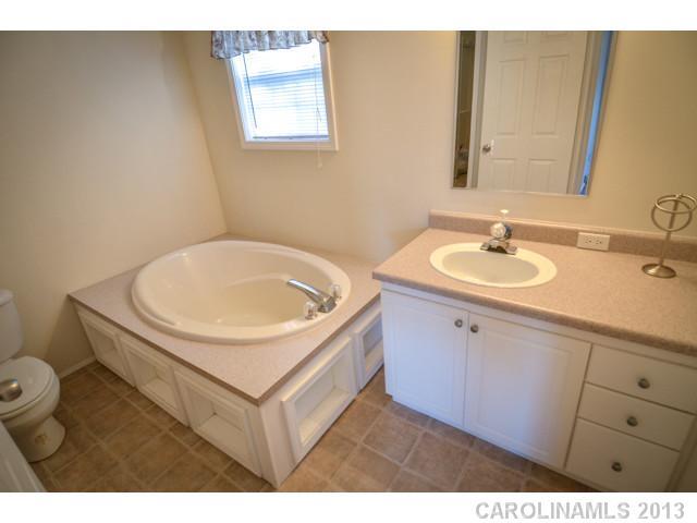 4520 Plyler Mill Road Monroe, NC 28112 - Photo 16 of 16 a bathroom with a sink and a mirror