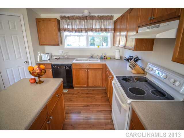 4520 Plyler Mill Road Monroe, NC 28112 - Photo 10 of 16 a kitchen with a stove a sink and a refrigerator