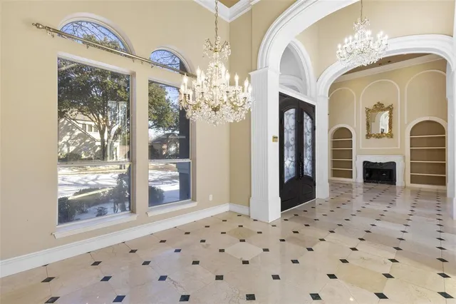 a view of a entryway door with chandelier