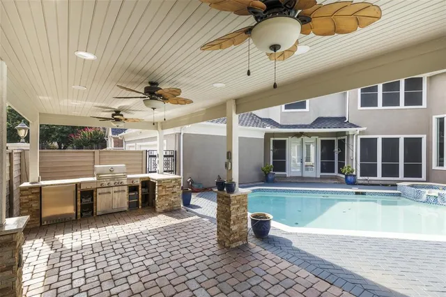 a view of a patio with a dining table and chairs with wooden floor