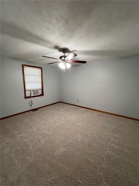 3743 Jiles Road Kennesaw, GA 30144 - Photo 15 of 21 an empty room with a ceiling fan and window