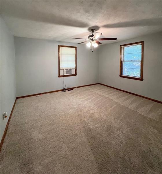 3743 Jiles Road Kennesaw, GA 30144 - Photo 16 of 21 an empty room with windows and ceiling fan