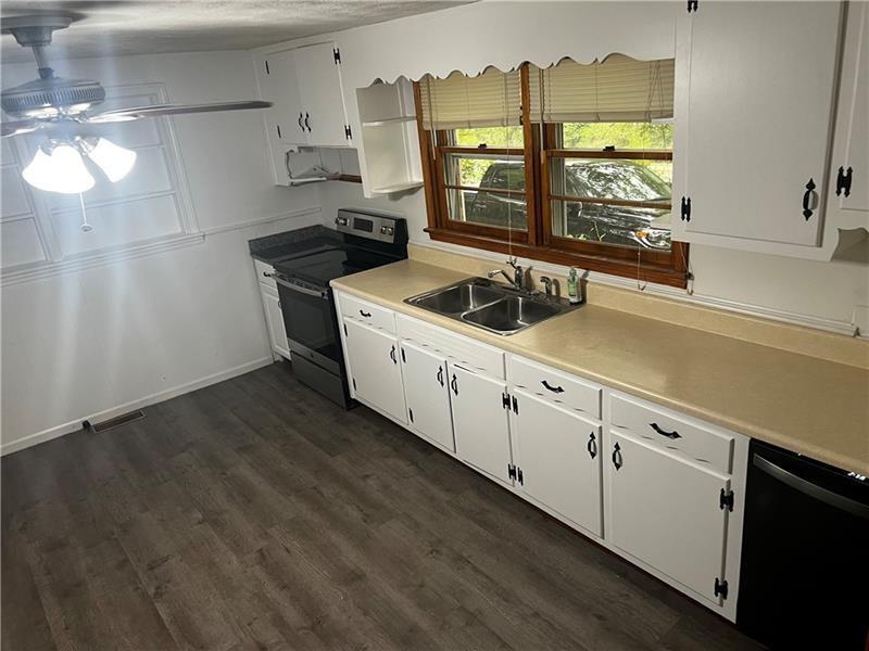 3743 Jiles Road Kennesaw, GA 30144 - Photo 6 of 21 a kitchen with stainless steel appliances a sink a stove and a window
